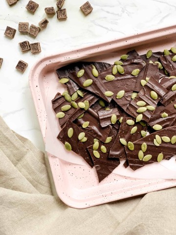 Pink Tray of Healthy No Bake Chocolate Pieces with Seeds on Top