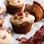 A maple nut banana muffin with maple frosting and bacon bits.