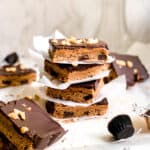 Stack of Homemade Dessert Bars with Peanut Butter and Melted Dark Chocolate