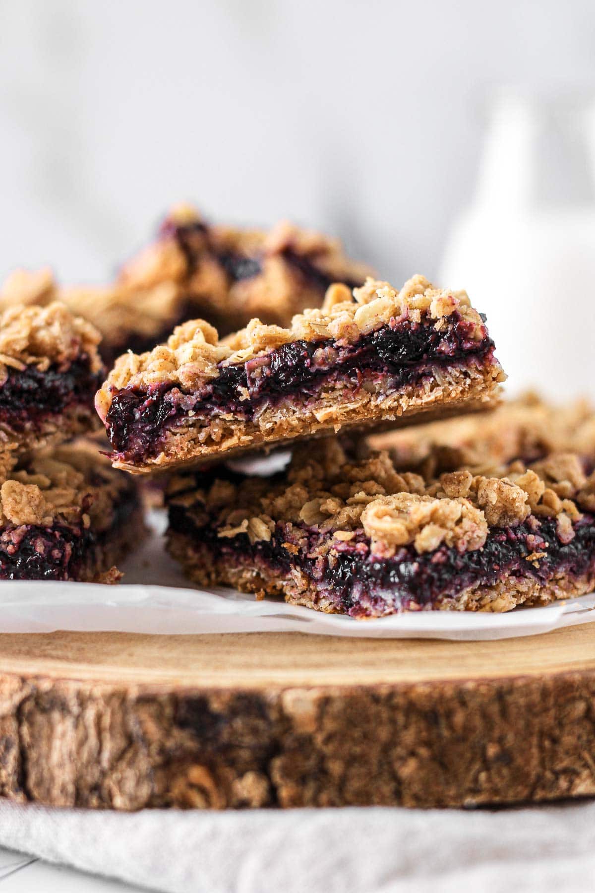 stack of blueberry oat bars with glass of milk for baking blog and food photography