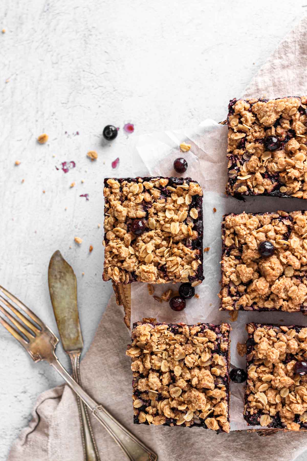 blueberry oatmeal bars with fork and knife for baking blog and food photography