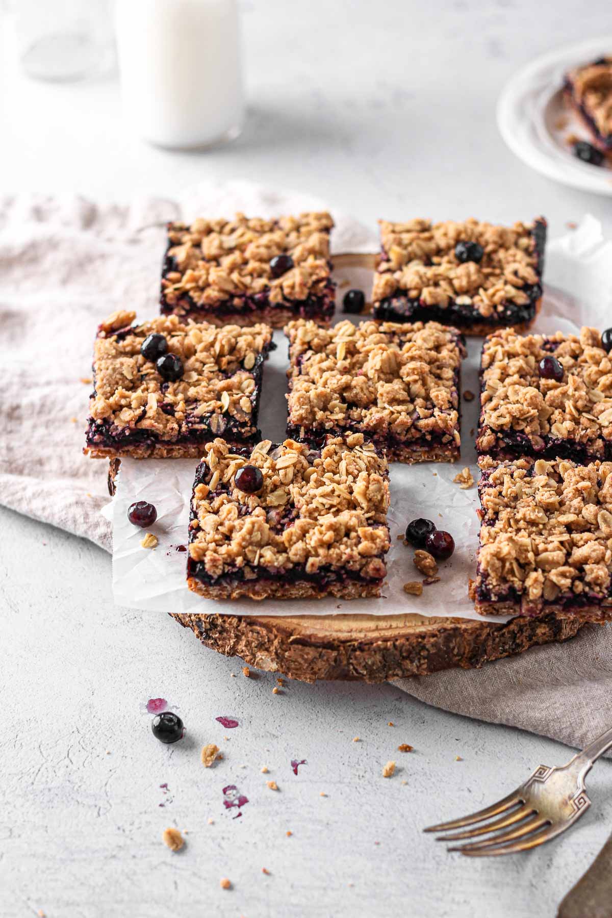 blueberry oat squares on parchment paper for baking blog and food photography