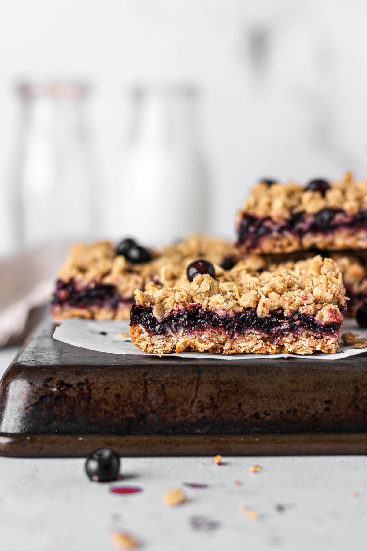 blueberry oatmeal bars with glass of milk for baking blog and food photography