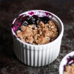 Two ramekins with blueberry crisp.