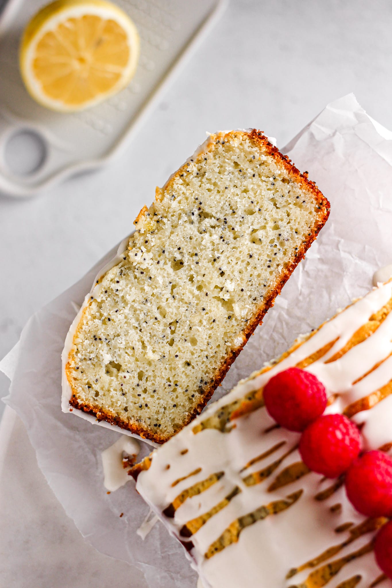 slice of lemon poppy seed pound cake with raspberries for baking blog and food photography
