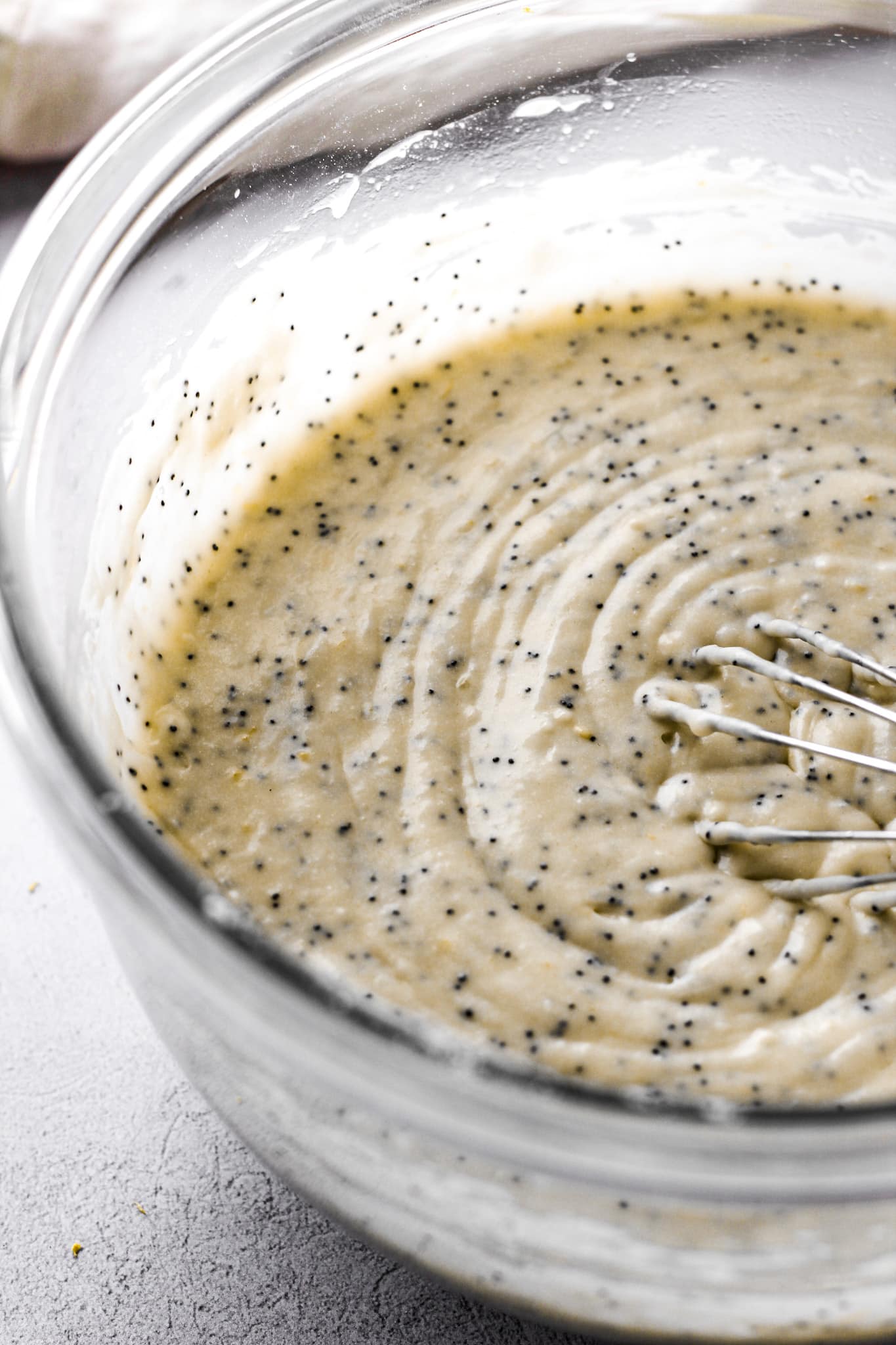 lemon poppy seed cake batter with a whisk for baking blog and food photography