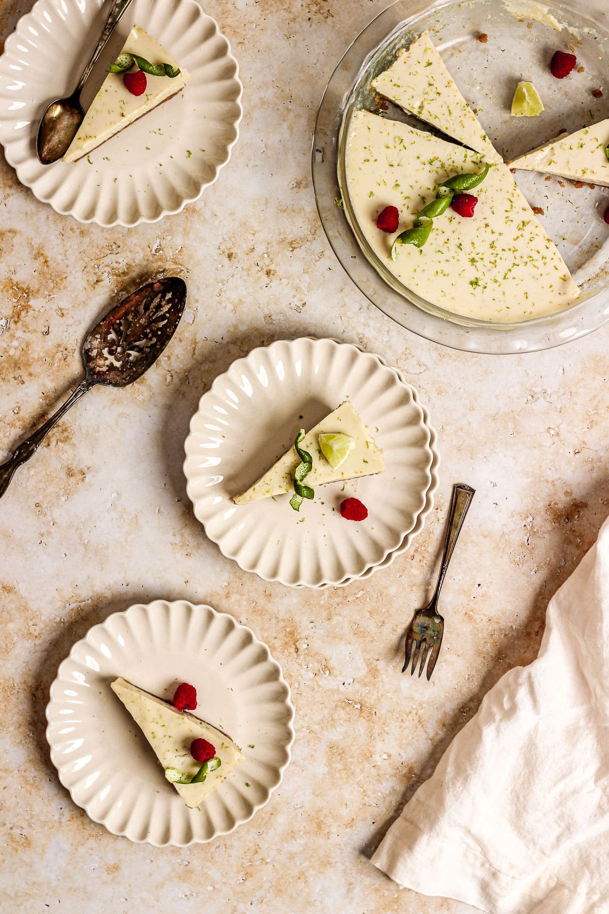 key lime pie with raspberries and lime garnish