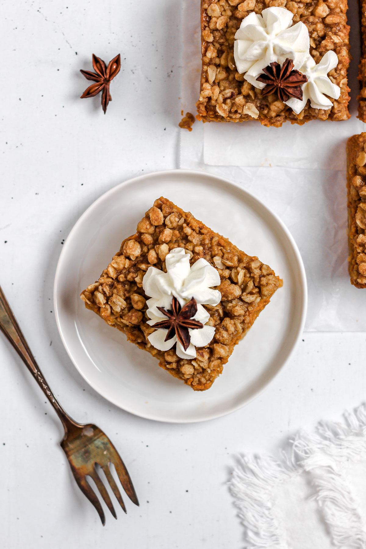 pumpkin pie bars with oatmeal streusel crumble topping and whipped cream