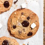 A s'mores cookie with melted chocolate chips and mini marshmallows.