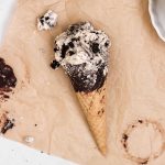 A sugar cone filled with homemade cookies and cream ice cream.