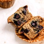 Banana blueberry muffin on parchment paper.