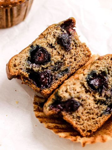 Banana blueberry muffin on parchment paper.