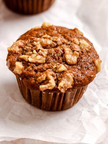 Banana walnut muffin on parchment paper.