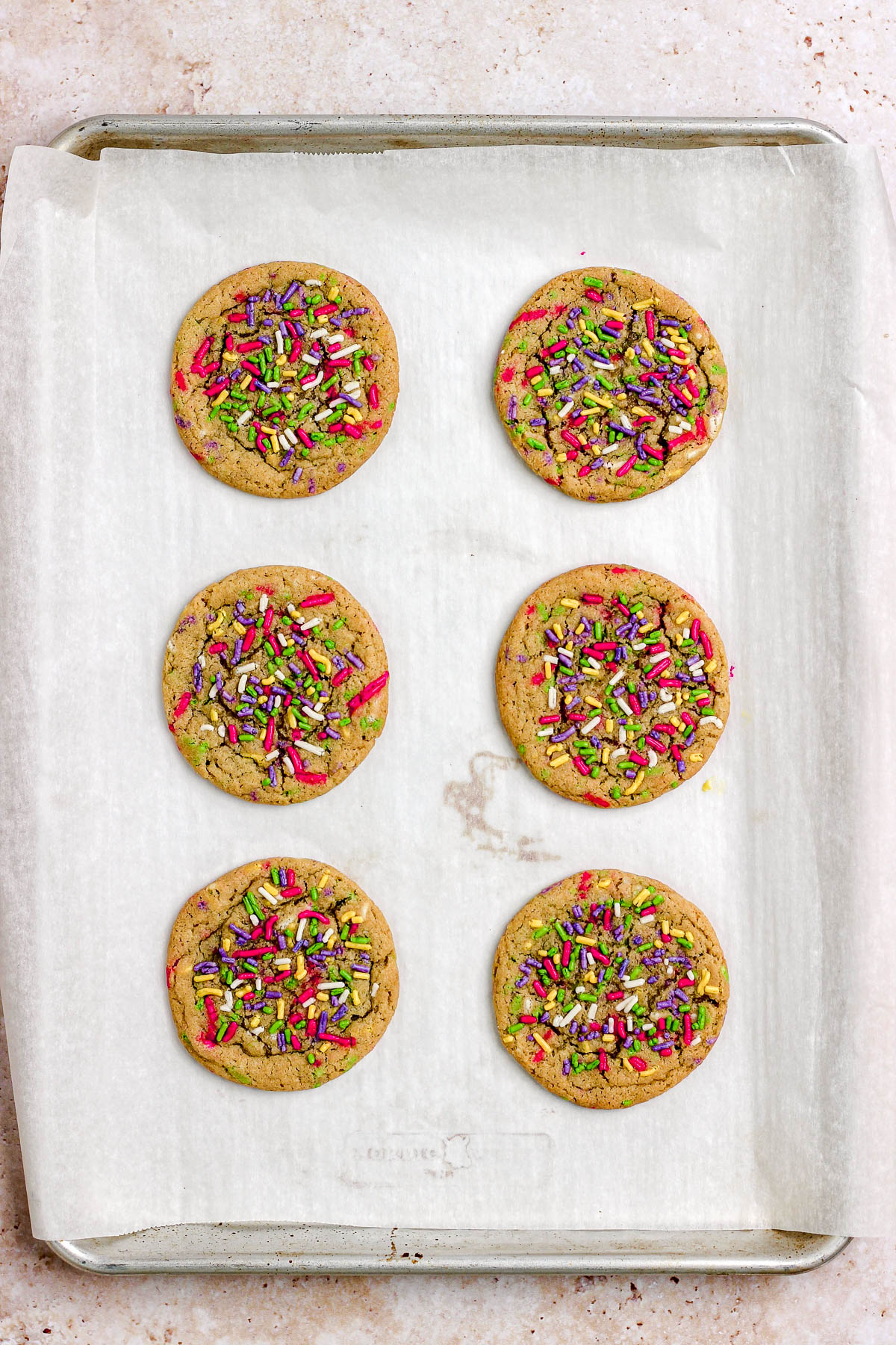 Sprinkle sugar cookies on a parchment paper lined baking sheet.