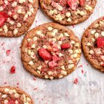 Strawberry white chocolate chip cookies on a parchment lined baking sheet.
