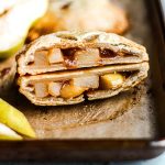 Pear hand pie cut in half revealing the juicy pear filling.