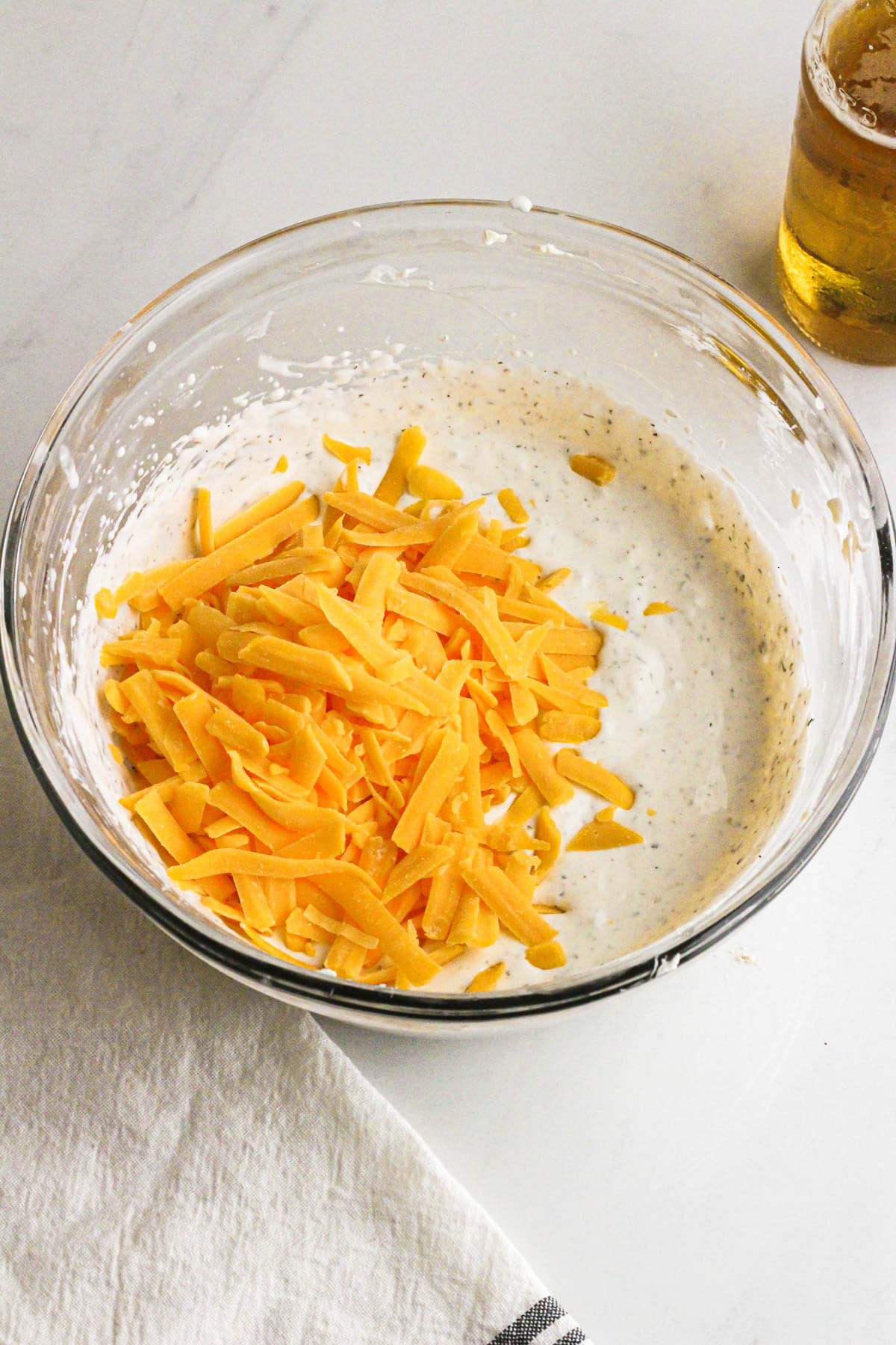 Cream cheese beer dip with shredded cheddar.