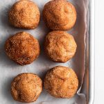 Cookie dough balls on a silver baking tray.