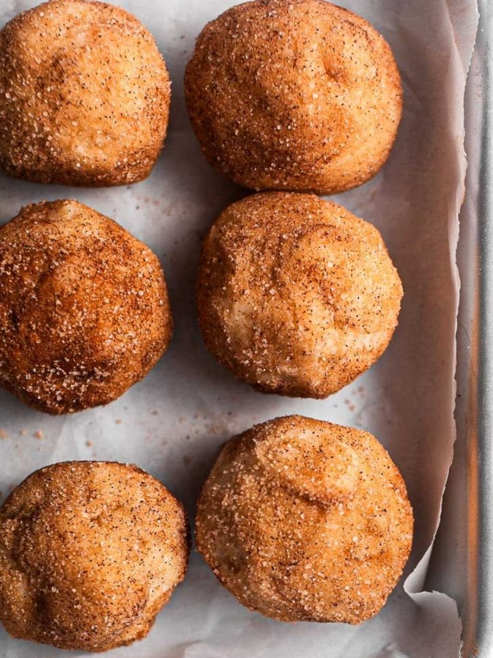 Cookie dough balls on a silver baking tray.