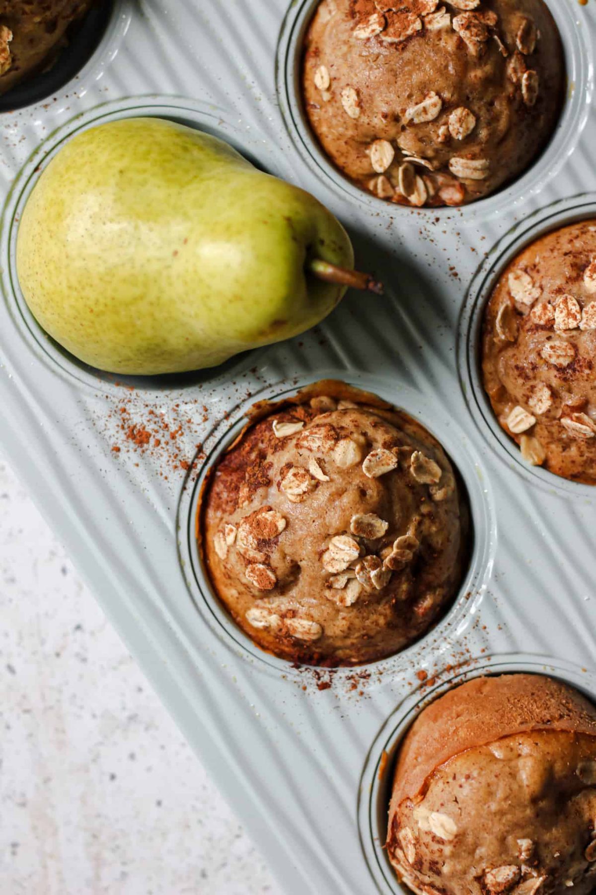 Pear Oat Muffins Flatlay of light blue muffin tin with pear muffins for food photography